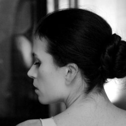 A woman with a bun in black and white.