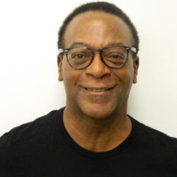A man with glasses and a black shirt