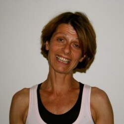 A woman with short hair is smiling for the camera.
