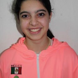 A girl in pink jacket smiling for the camera.