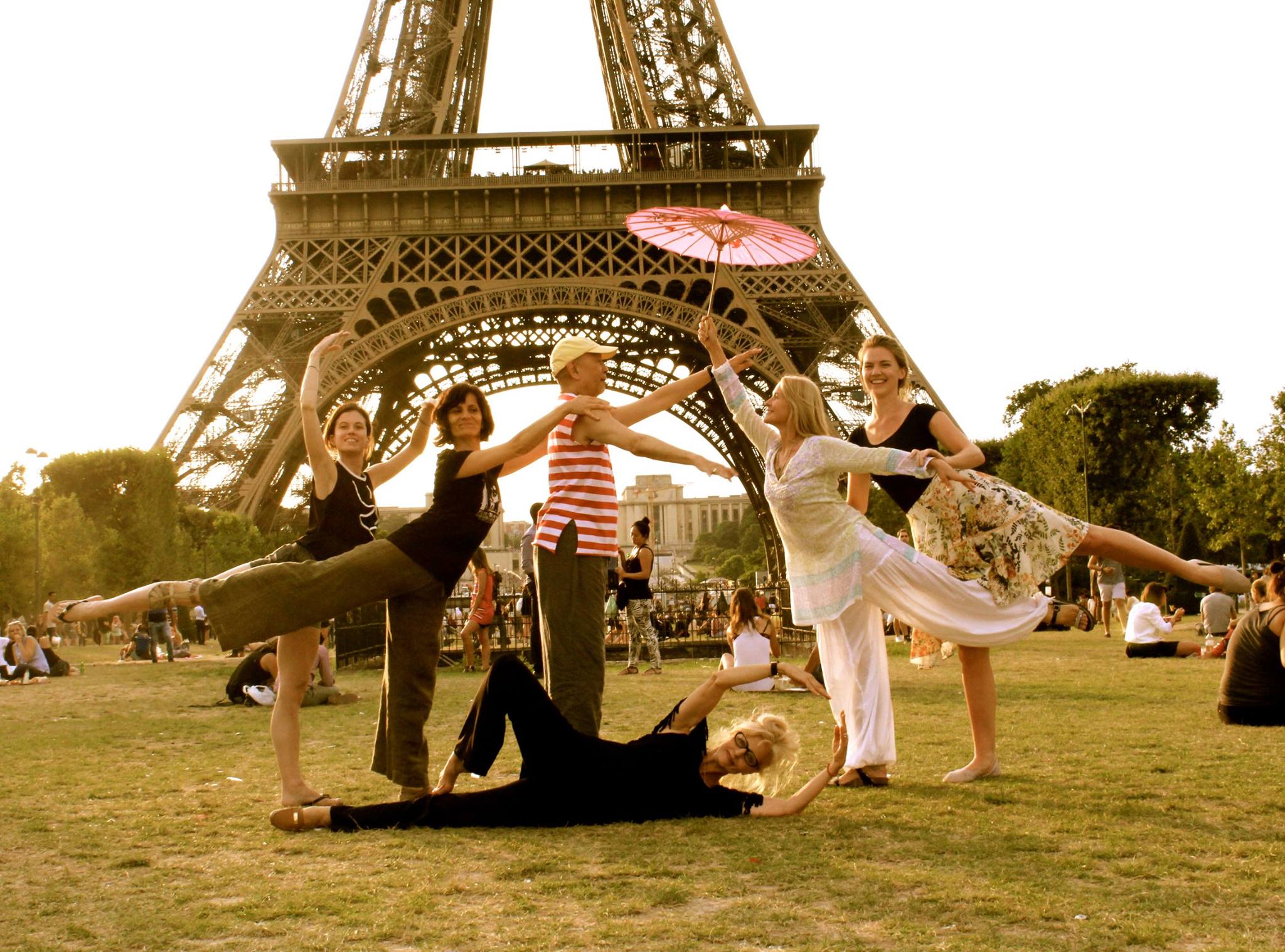a group of people posing for a picture near the Eiffel tower