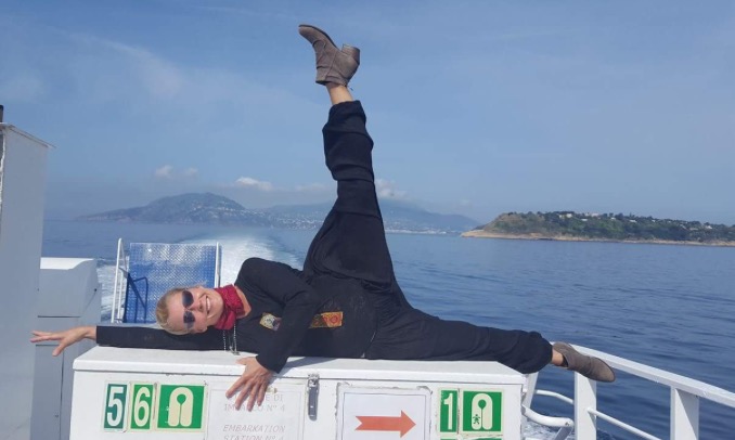 a person doing the floor-barre exercise on a boat