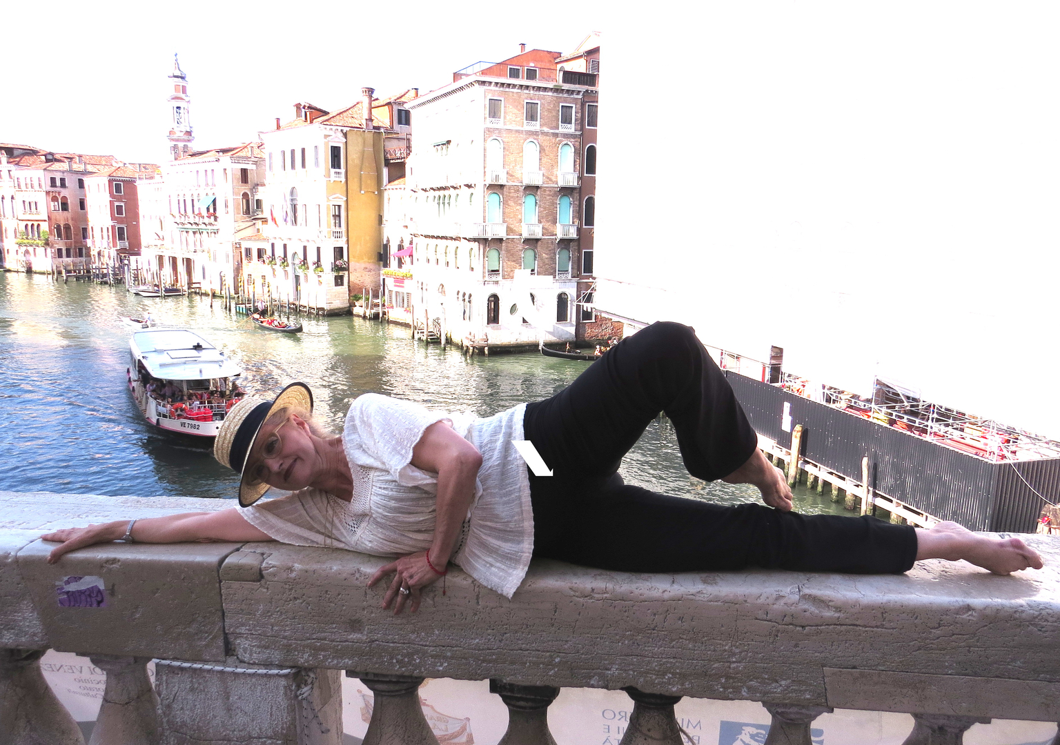 a person doing the floor-barre exercise near a canal