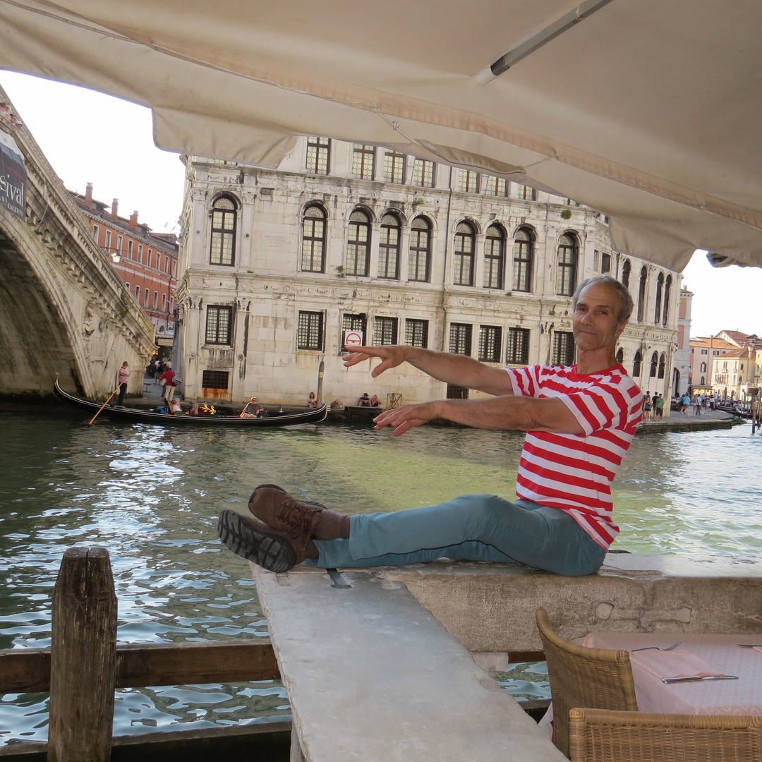 a person doing the floor-barre exercise next to a canal
