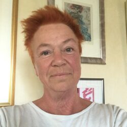 A woman with red hair and white shirt